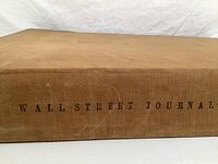 Side view showing 'Wall Street Journal' printed on spine of large book