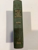 Spine of book showing title Walks and Rides About Boston by Bacon with publisher Houghton Mifflin & Co. stamped at bottom.