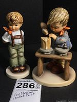 Both Goebel Hummel figurines side by side showing detail and proportion.