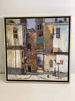 Frontal view of the framed oil on canvas street scene painting depicting multiple buildings and architectural details.