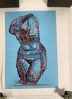 Photo of large rolled print of stylized classical torso bust figure in blue and red colors