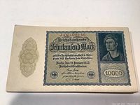 Single 10000 Mark Reichsbanknote front showing portrait of worker, details including serial number and denominations