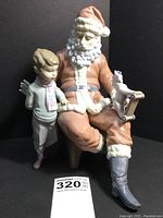 Front view showing Santa Claus seated with boy and toy horse.
