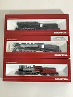 Three Mantua boxed HO scale model trains stacked with front foam window display, showing locomotives and tenders.