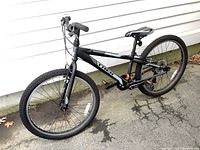 Side angle view showing full bike frame, tires, pedals, and seat detail.