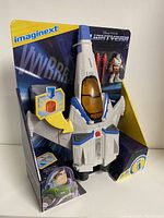 XL-15 Spaceship in packaging with Buzz Lightyear figure and missile accessories visible, showing front angle.
