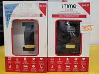 Two boxed iTime Elite smart watches with rectangular faces and black silicone bands visible through packaging windows. Boxes display brand name, price, and key features.