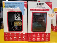 Two boxed iTime Elite smartwatches showing packaging and device with black and white silicone band visible.