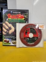 Photo showing Donkey Kong Jungle Beat game case alongside the Super Smash Bros game disc and music CD in clear plastic case.