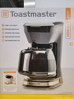 Box front showing Toastmaster 12 cup coffee maker with removable brew basket and pause and serve function.