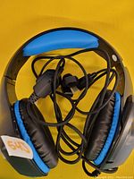 Blue and black wired over ear gaming headset with microphone and braided cable, ear cushions and headband padded. Untested condition.