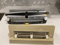 Side view of bookbinder and hole punch showing overall condition and parts