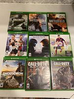 Photo showing the front covers of all 10 Xbox One games laid out flat.