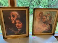 Two framed Native American art prints side by side on a table with a green outdoor background.
