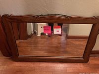 Full view of wood framed mirror showing size, shape, and overall condition