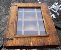 Top view of antique wooden display case showing internal compartments and glass cover.
