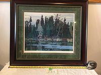 Front view of framed print with measuring tape showing width