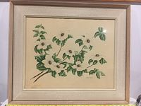Framed watercolour painting showing white dogwood flowers with green leaves and brown centers, set against neutral background. The signature of artist Dorothy E. Michell appears on lower right. Frame is wooden with beige mat and glass covering.