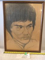 Framed charcoal drawing portrait of Bruce Lee signed by artist R. Mitchson in March 1995, in good condition, with ruler showing size.