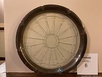 Front view showing the full round tray with sterling silver rim and cut crystal center on a neutral background.
