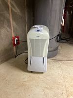 Front view of the Danby dehumidifier showing control panel and power cord.