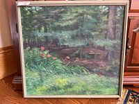 Full view of the framed acrylic painting showing the wooded area with lush green foliage and orange flowers in the foreground.