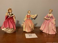 Three Royal Doulton figurines side by side