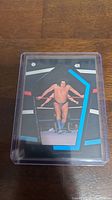 Front of 1985 Topps Andre The Giant sticker showing wrestler in the ring with multicolor geometric border.