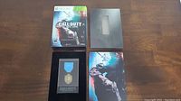 Call Of Duty Black Ops Hardened Edition items including game case, medal in presentation case, and collector's box