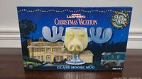 Photo showing the front of the original box packaging with branding and image of moose mug.