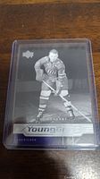 Front of Don Cherry Young Guns hockey card showing black and white image of Don Cherry in hockey gear, card is in plastic sleeve.
