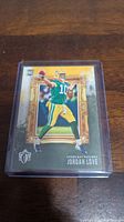 Front of Jordan Love rookie card showing player in Green Bay Packers uniform with gold frame design.