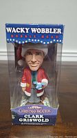 Front view of the boxed Clark Griswold Wacky Wobbler bobble head showing the figure clearly through transparent packaging.