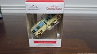 Front view of Hallmark ornament box with Cousin Eddie's RV ornament inside.