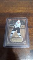 Front of Sidney Crosby rookie card showing the player in action with gold/brown decorative background.