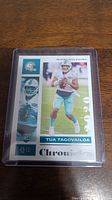 Front of Tua Tagovailoa rookie football card from 2020 Chronicles series showing player in Miami Dolphins uniform, team logo, rookie card designation, and Chronicles label.
