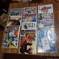 Photo showing the full set of 11 comic books arranged on a surface with covers clearly visible.