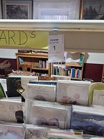 Front view of card stand with greeting cards arranged in rows and a label indicating 'ALL CARDS'