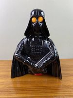 Front view of ceramic Darth Vader figurine, black gloss finish, eyes and lightsaber unlit