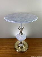Full front view of the accent table showing marble top and brass base