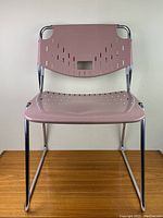 Front view showing mauve perforated seat and backrest with chrome tubular frame.