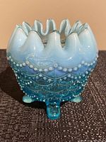 Front view of the blue opalescent hobnail rose bowl showing the ruffled edge and hobnail design.