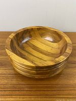 Top-down view of the round wooden bowl showing smooth wood grain and natural color variations.