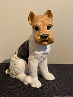 Front view of the terrier ceramic dog figurine showing white, black, and brown color details and glossy finish.