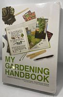 Front of the sleeve showing gardening journal sketches, photos, and tools alongside the title My Gardening Handbook