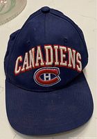 Front view showing 'CANADIENS' text and Canadiens 'CH' logo in embroidery on navy blue cap.