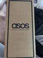 Closed ASOS cardboard box containing the sandals