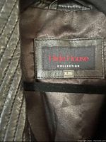 Close-up interior label showing Hide House Collection with size XL/G tag.