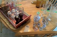 Overview photo showing vintage metal tray, salt and pepper mills, various drinking glasses including Guinness glasses, beer mug, and the liqueur set with 7 glasses and a carafe.