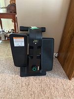 Front view showing the foot pedals, digital display, and control knob